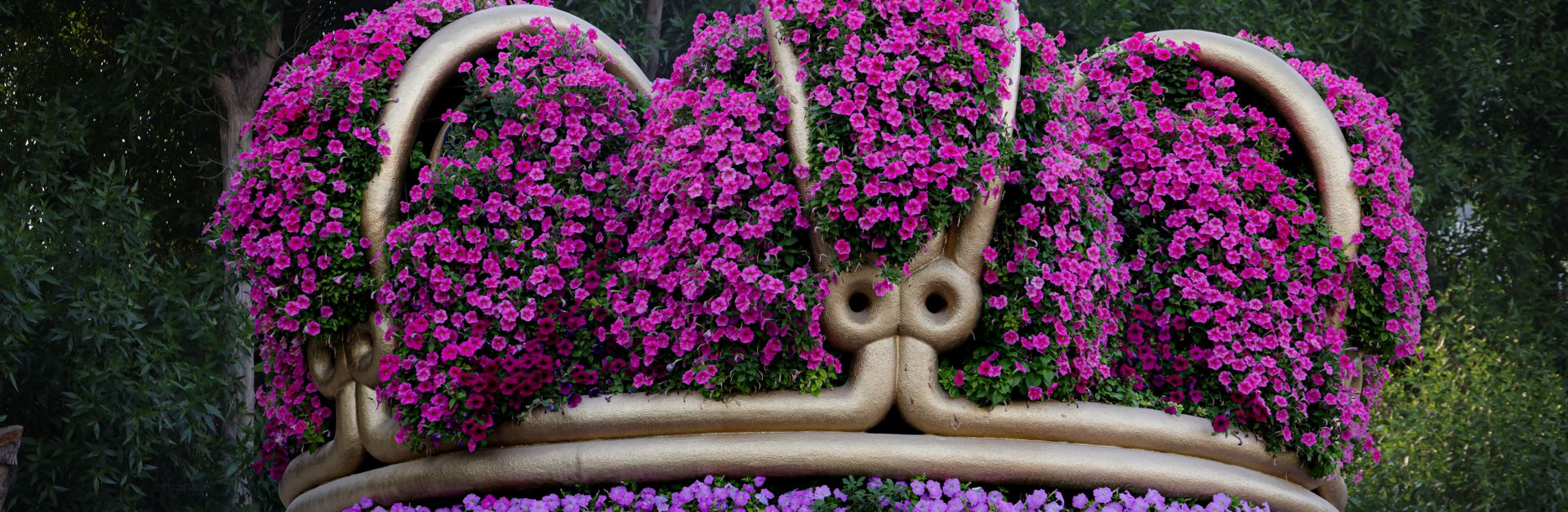 Stunning crown-shaped garden sculpture adorned with vibrant purple flowers, creating an enchanting a