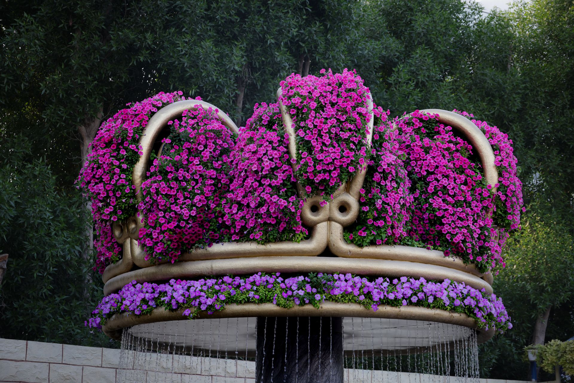 Stunning crown-shaped garden sculpture adorned with vibrant purple flowers, creating an enchanting a