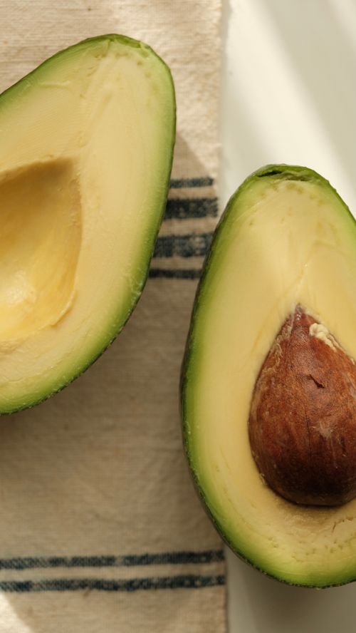 Free Close-up of ripe avocado halves; healthy eating concept. Stock Photo