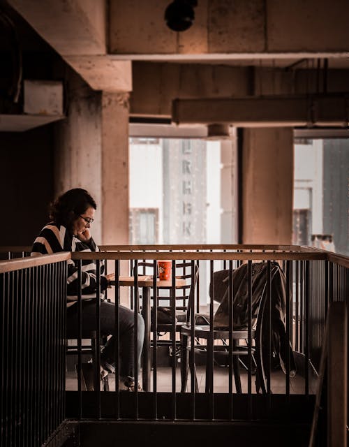 Lonely woman with book and coffee in cafe