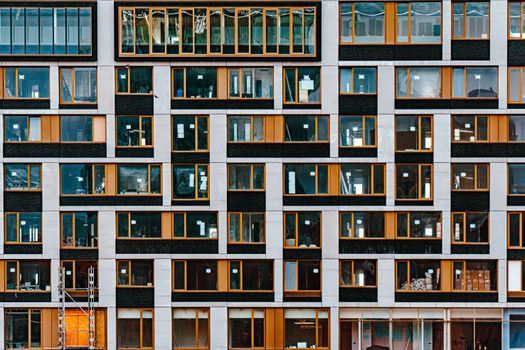 Closeup of a modern building facade with symmetrical windows in Rotterdam, Netherlands.