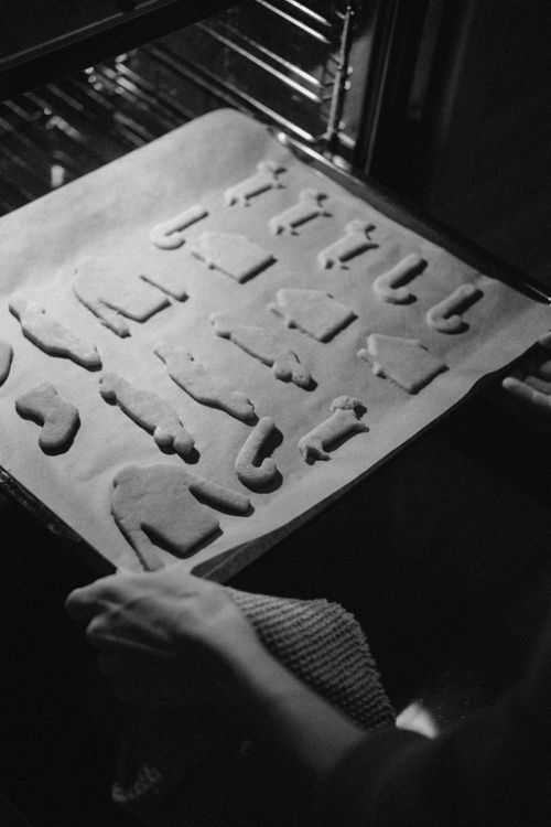 Free Monochrome image capturing baking cookies shaped in various designs on a tray. Stock Photo