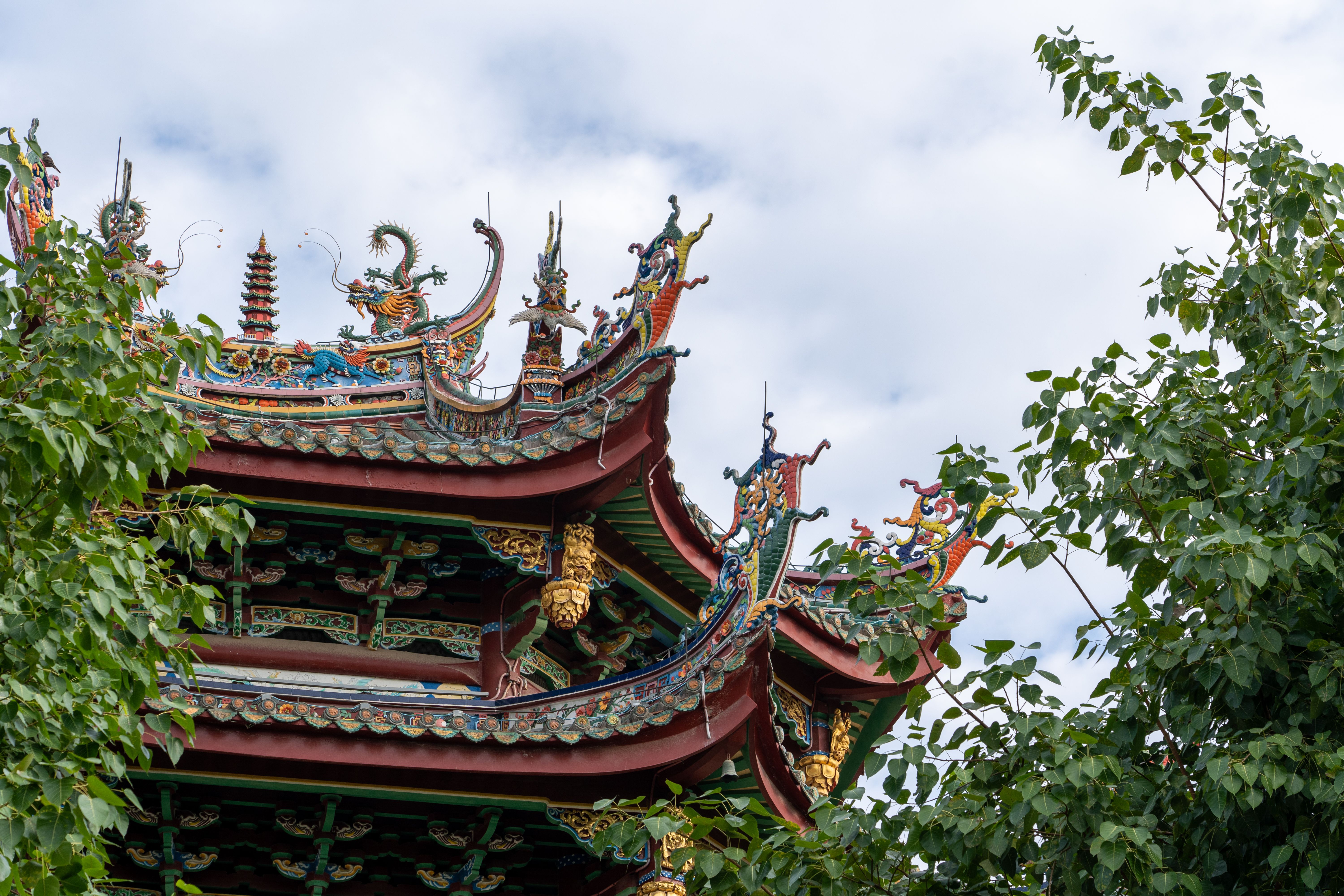 Intricate Chinese Temple Roof Surrounded by Trees · Free Stock Photo