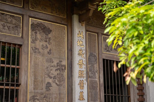 Beautiful detailed wood carvings on a traditional Asian building facade.