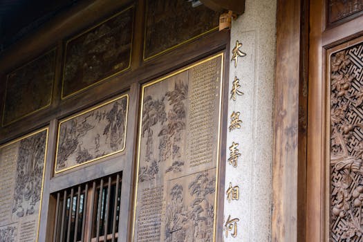 Detailed image of traditional Asian temple wood carvings with artistic engraved designs.
