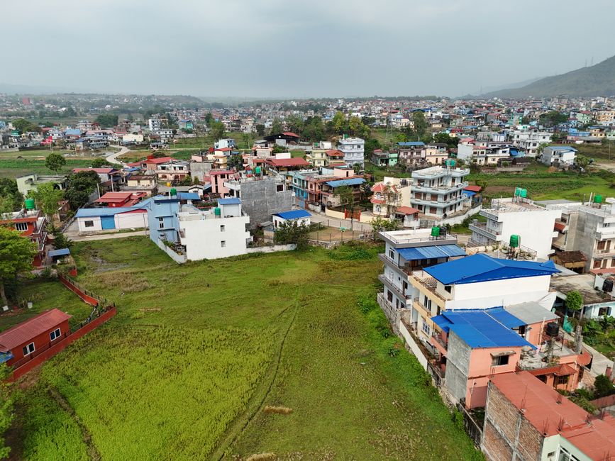 Amazing Himalayan Gosaikunda Helicopter Tour from Kathmandu Review 2026 - Aerial shot capturing a diverse and colorful residential neighborhood in summer, Nepal.
