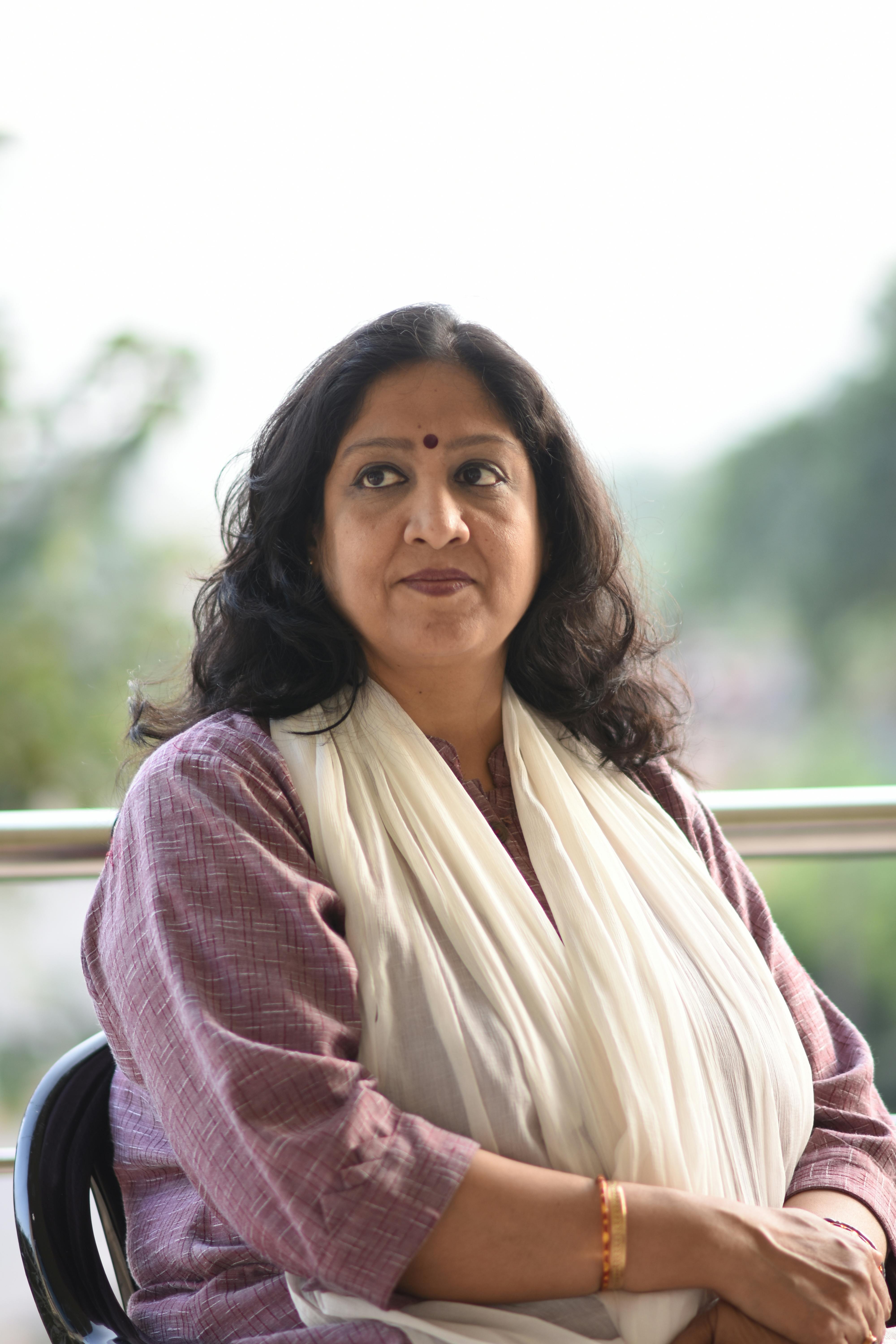 Calm portrait of an Indian woman in traditional attire outdoors.