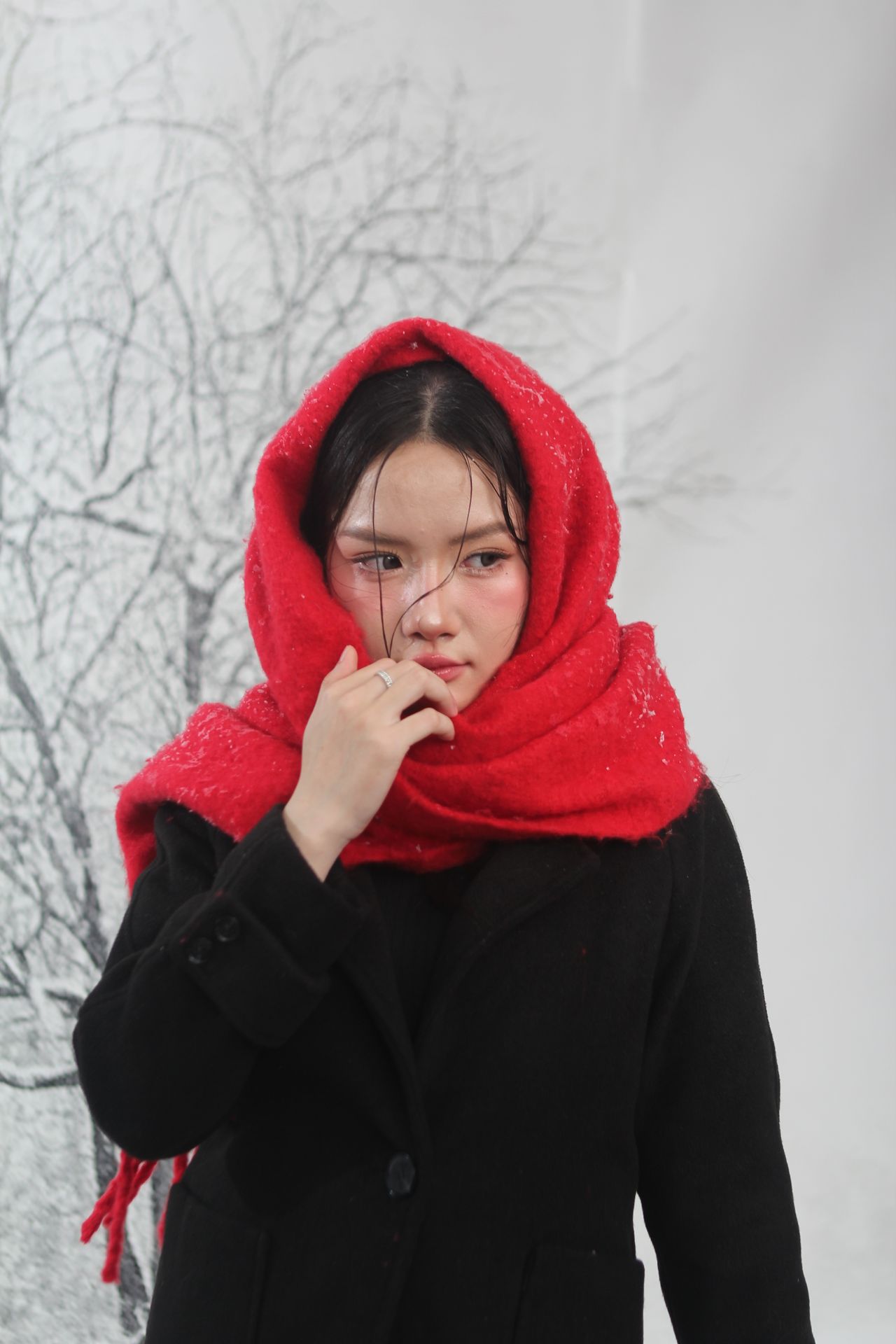 Woman with a red scarf wrapped around her head and neck