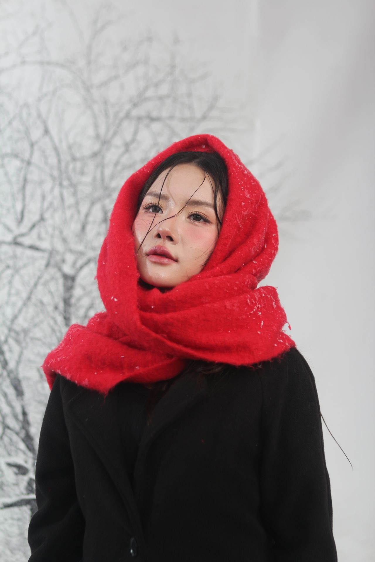 Woman with a bright red scarf wrapped as a hood