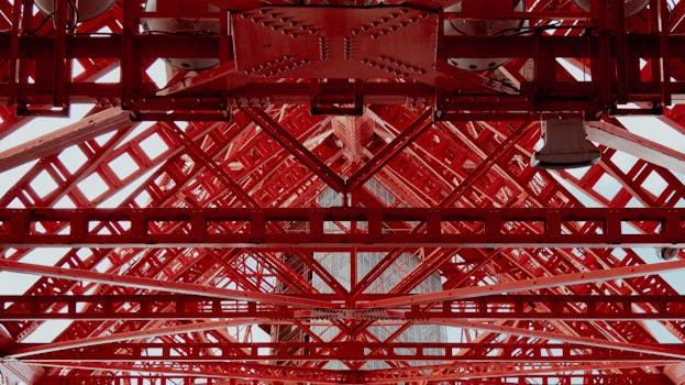 Detailed view of a red steel framework showing geometric patterns and industrial design.