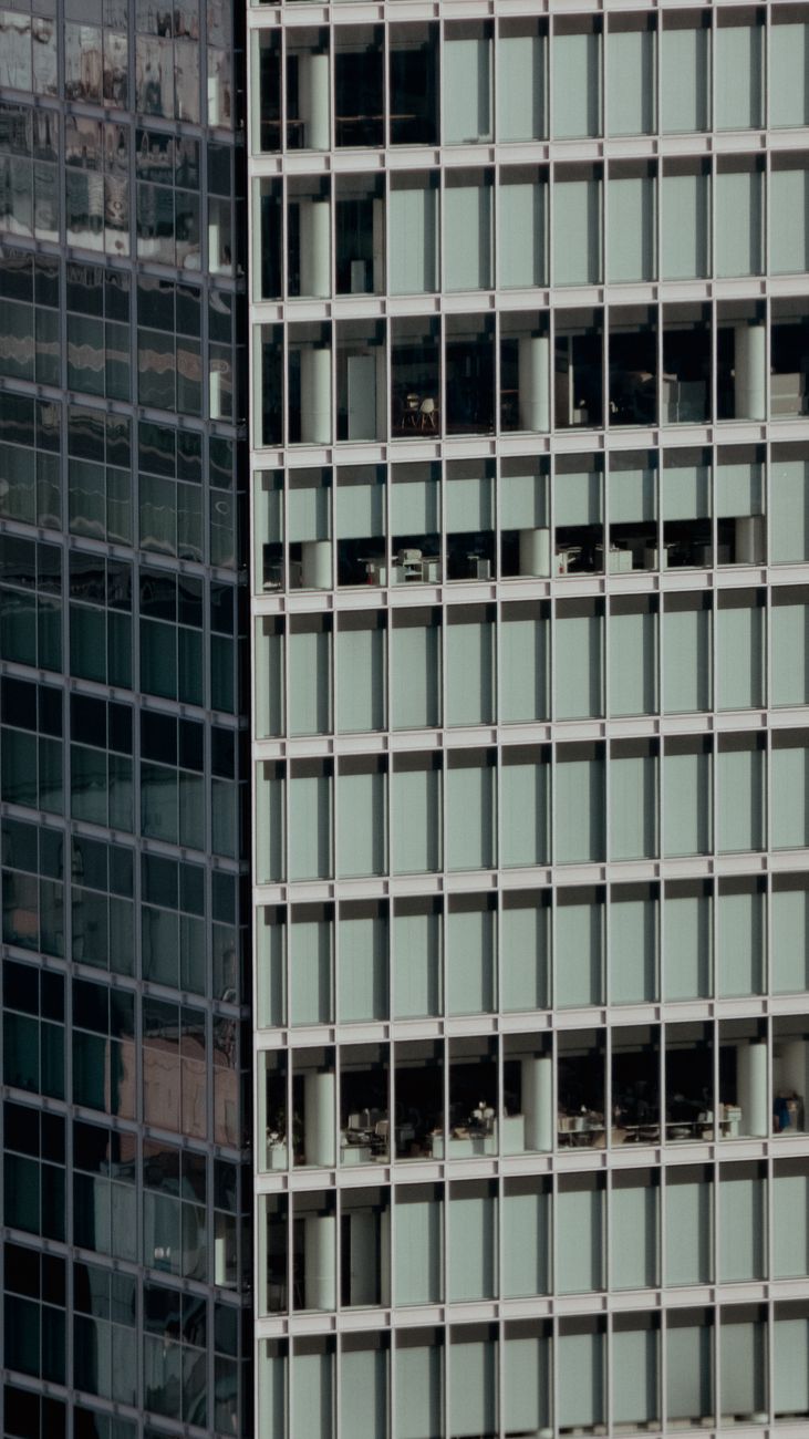 A view of a modern office building with glass windows, showcasing urban architecture.