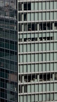 A view of a modern office building with glass windows, showcasing urban architecture.