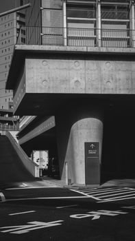 Black and white photo of modern urban architecture with geometric lines and concrete textures.