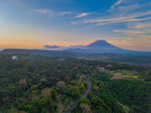 Free Stunning aerial landscape of Mount Agung in Bali, Indonesia during sunset with lush greenery. Stock Photo