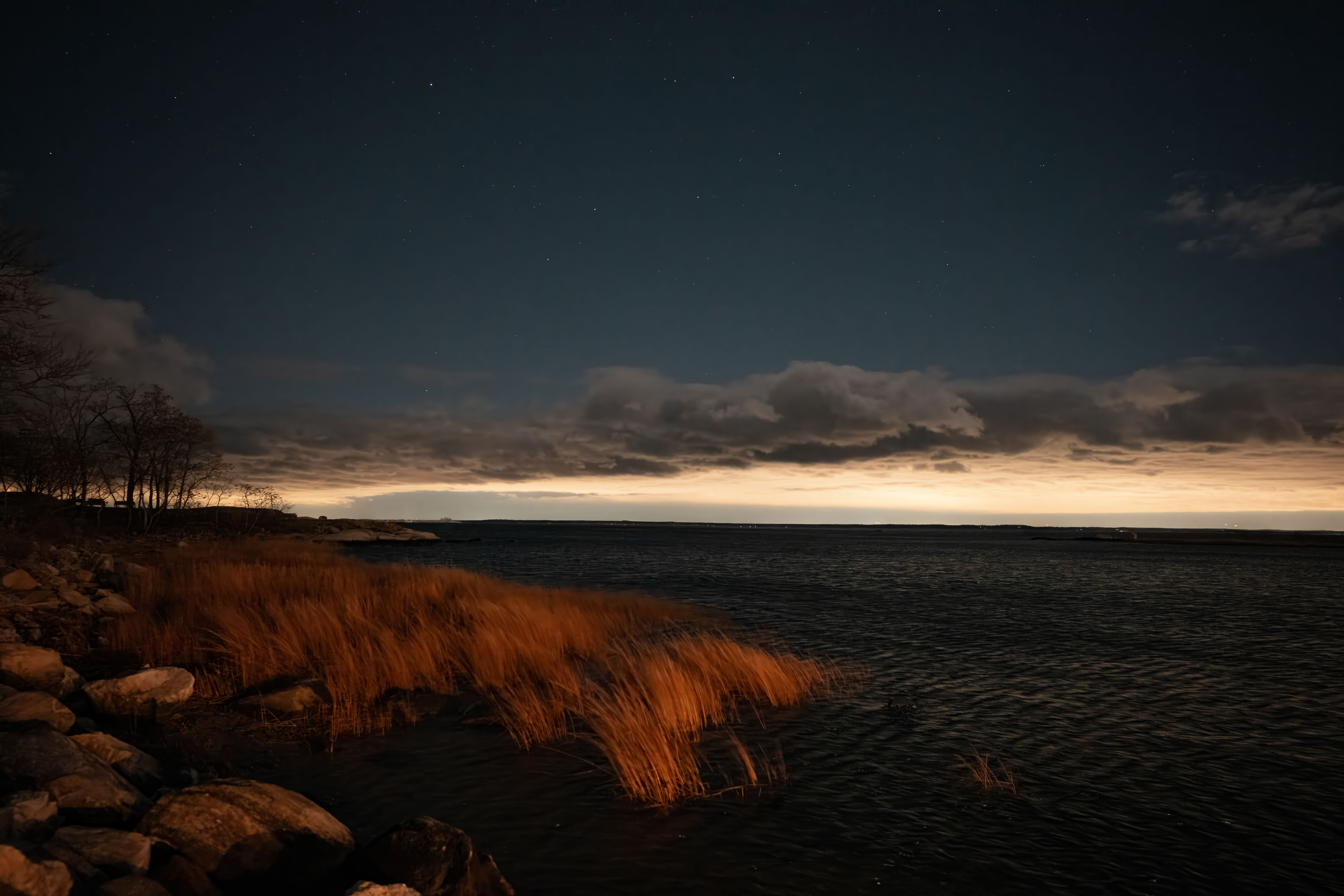 Peaceful twilight scene at Cove Island Park, Stamford, showcasing autumn colors and a serene seascape.