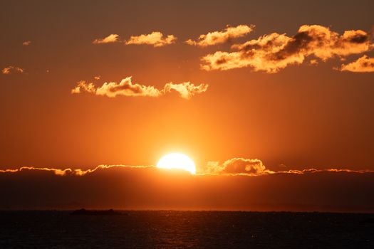 Stunning sunrise over the ocean with dramatic clouds and vibrant colors, captured in Stamford, Connecticut.