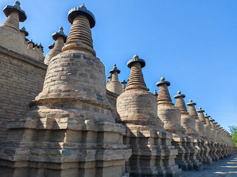 Rows of historic pagodas with distinct architecture under a clear blue sky, highlighting ancient design.