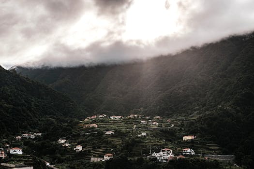 Stunning view of Boaventura village nestled in Madeira mountains under dramatic clouds.