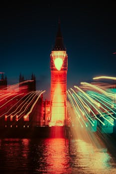 Vivid long exposure of Big Ben at night with neon light trails creating a cyberpunk atmosphere.