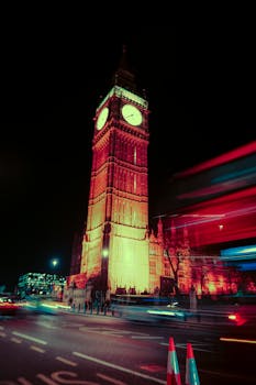 A striking night cityscape of Big Ben with motion blur and neon lights in London.
