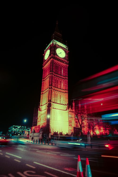 Free A striking night cityscape of Big Ben with motion blur and neon lights in London. Stock Photo