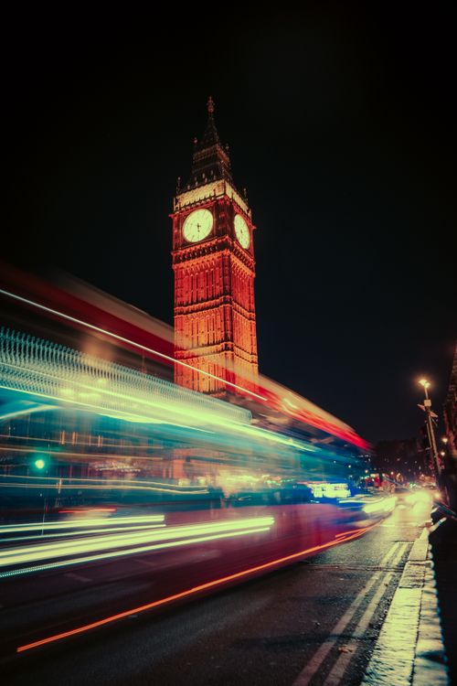 Free Dynamic night scene of Big Ben in London with vibrant light trails and a moody urban atmosphere. Stock Photo