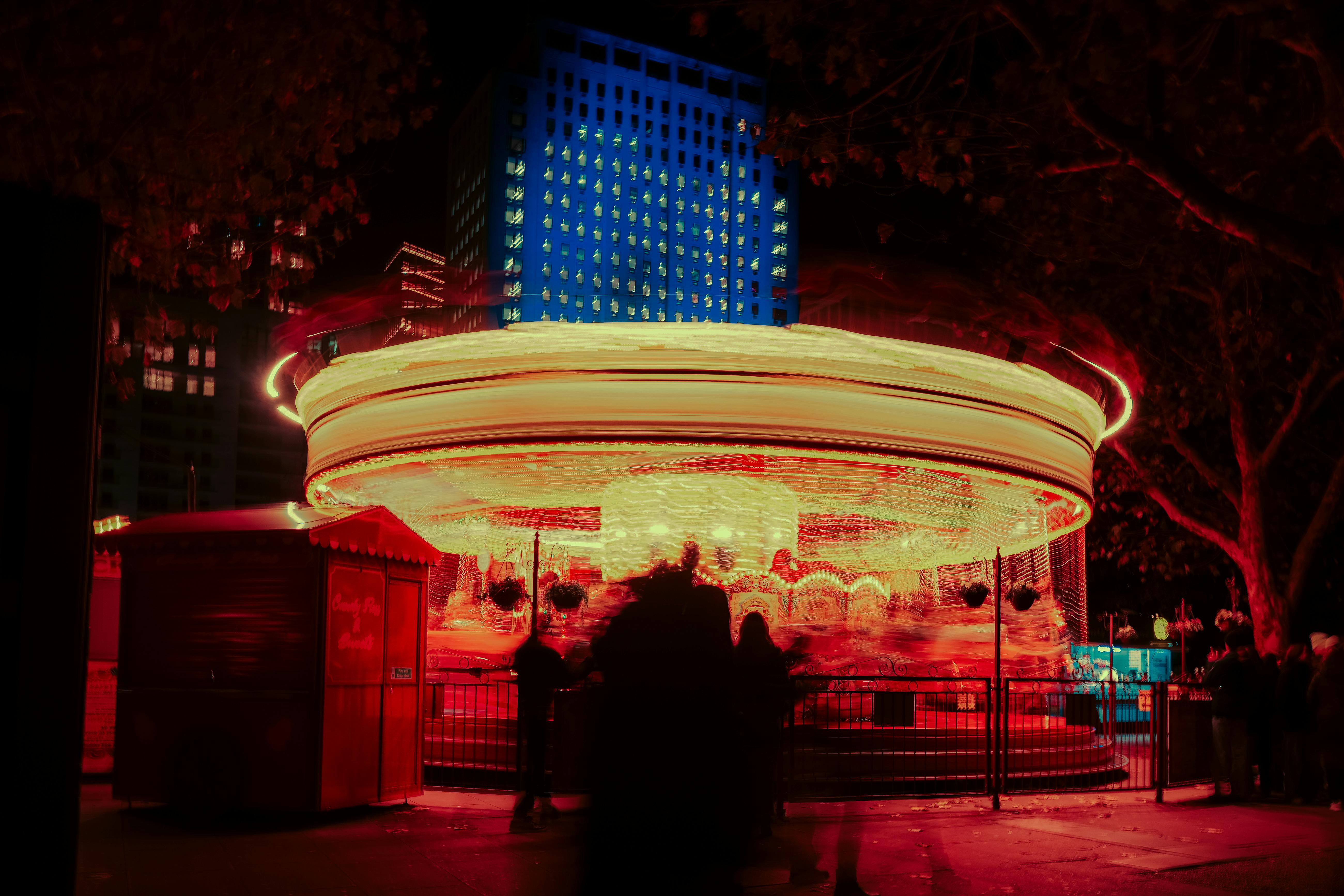 Long exposure shot of a colorful carousel spinning at night in London.