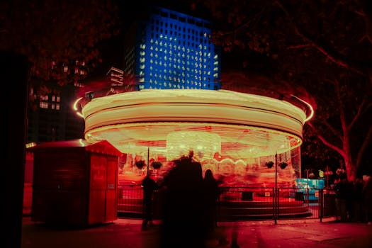 Long exposure shot of a colorful carousel spinning at night in London.