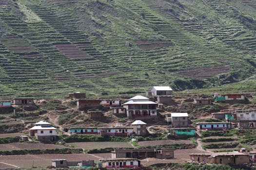 Beautiful view of a mountain village with terraced agricultural fields and traditional houses.