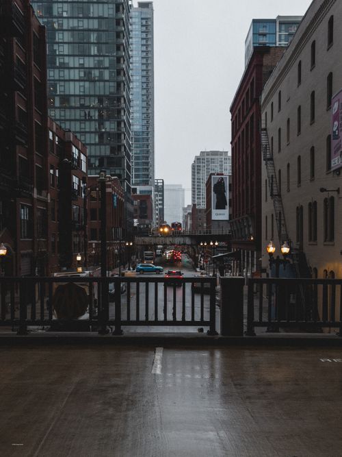 Free Moody urban street view of downtown cityscape with tall buildings and traffic. Stock Photo