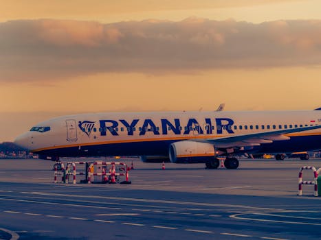 Ryanair airplane parked at Wroclaw airport during a beautiful sunset.