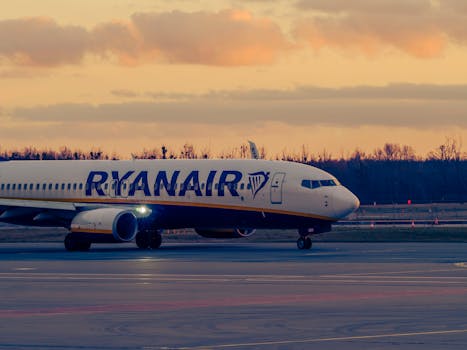 Ryanair airplane taxiing at Wrocław airport during sunset. Scenic evening view.