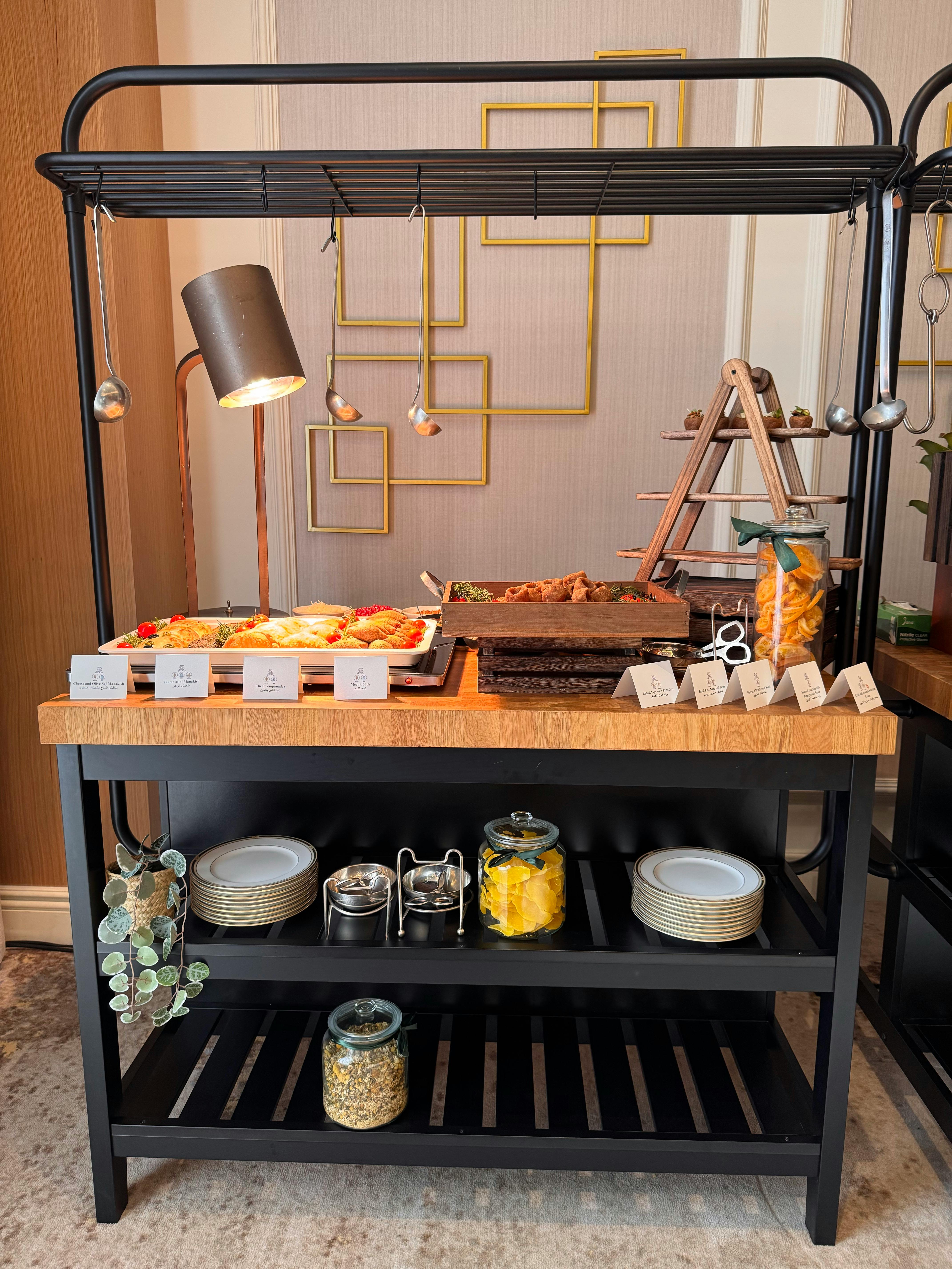 Diverse buffet arrangement featuring appetizers, snacks, and condiments on a stylish display.
