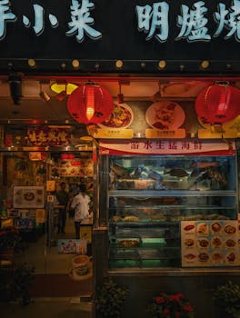 Capture the vibrant atmosphere of a Hong Kong street market at night, showcasing illuminated storefronts and bustling activity.