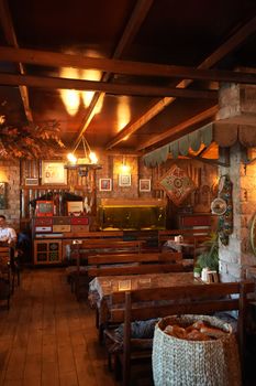 Warm and inviting rustic restaurant interior with wooden furniture and decor.