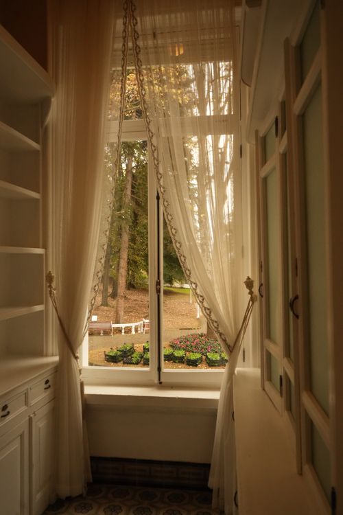 Free Charming hallway view with elegant curtains and garden scenery outdoors. Stock Photo