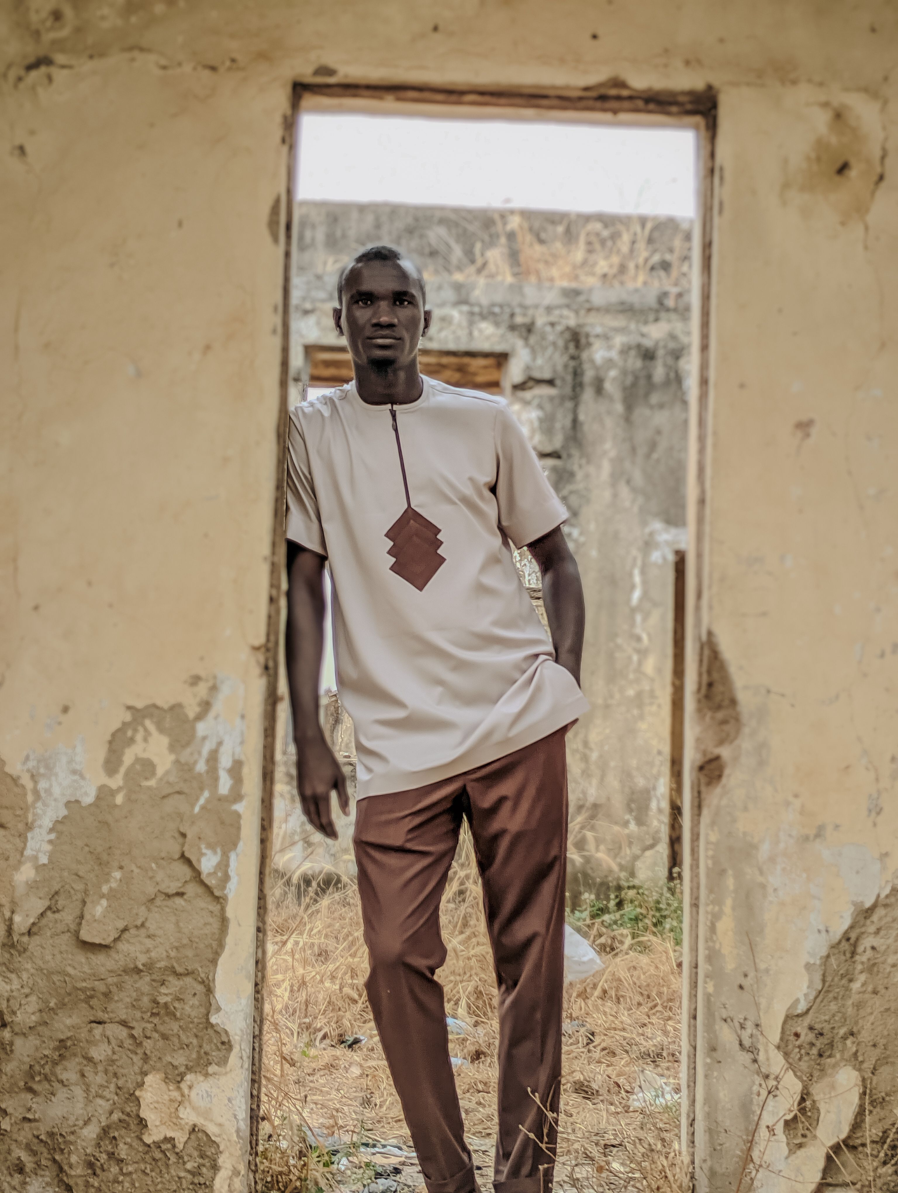 Stylish Man Posing in Rustic Architectural Frame · Free Stock Photo