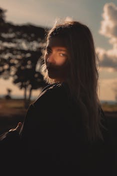 A serene portrait of a woman during golden hour in Brazil, evoking warmth and tranquility.
