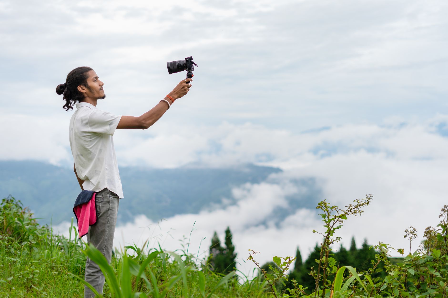 Young creator filming outdoor scenery with a camera