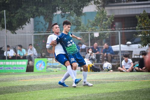Free Soccer players battling on the field during a lively match in Hanoi, Vietnam. Stock Photo