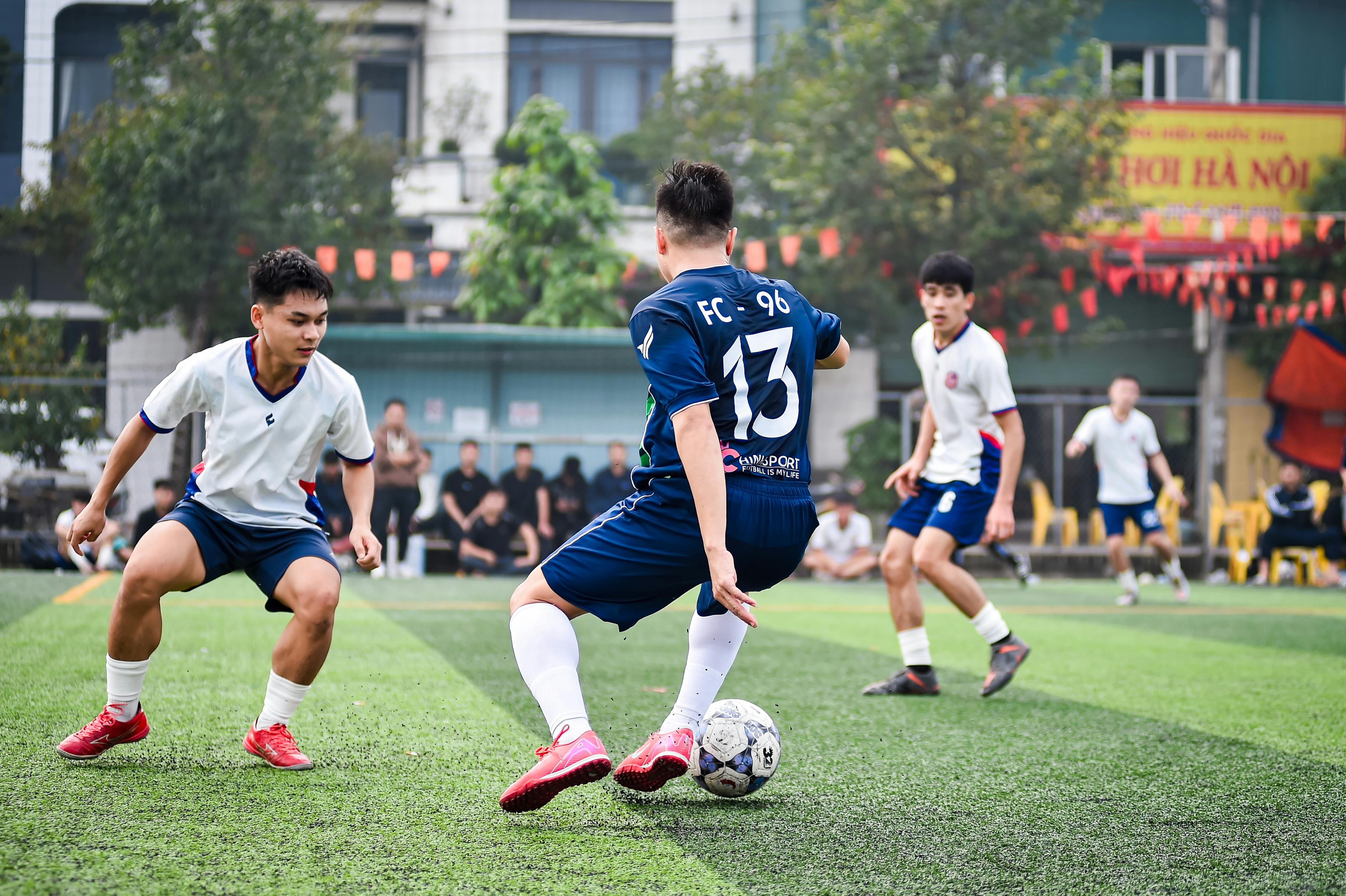 Dynamic soccer game on artificial turf in Hanoi, capturing athleticism and team spirit.
