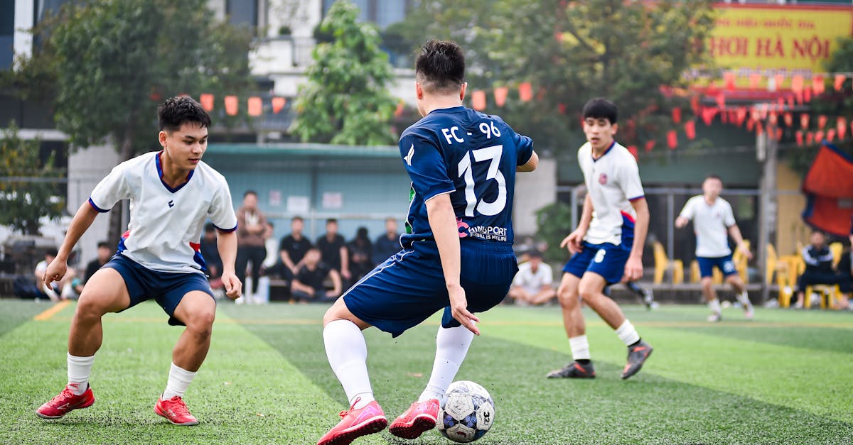 Dynamic soccer game on artificial turf in Hanoi, capturing athleticism and team spirit.
