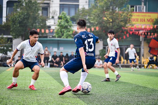 Dynamic soccer game on artificial turf in Hanoi, capturing athleticism and team spirit.