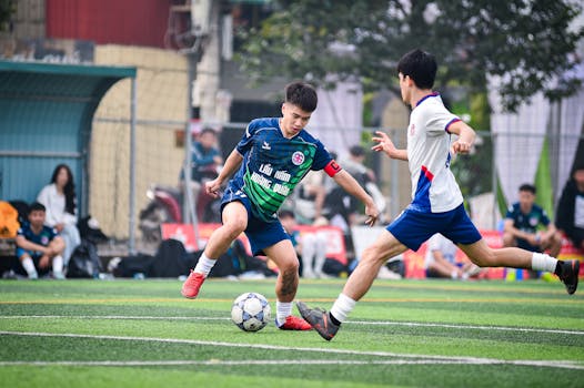Action-packed soccer match on artificial turf in Hanoi, Vietnam showcasing player agility and teamwork.