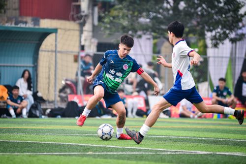 Free Action-packed soccer match on artificial turf in Hanoi, Vietnam showcasing player agility and teamwork. Stock Photo