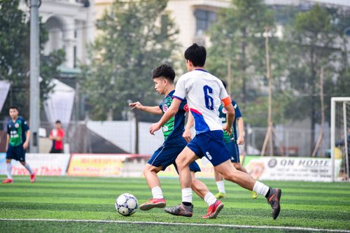 Free Intense youth soccer game on an artificial turf in Hà Nội, capturing sportsmanship and action. Stock Photo