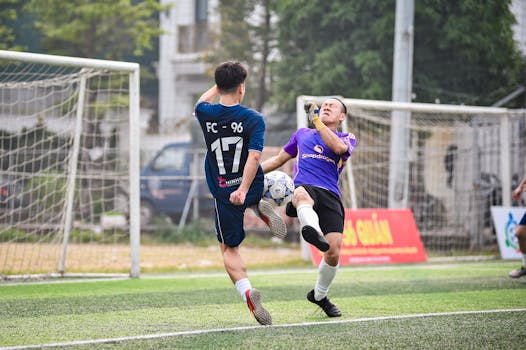 Exciting moment captured between two soccer players during a game in Hà Nội, Vietnam.