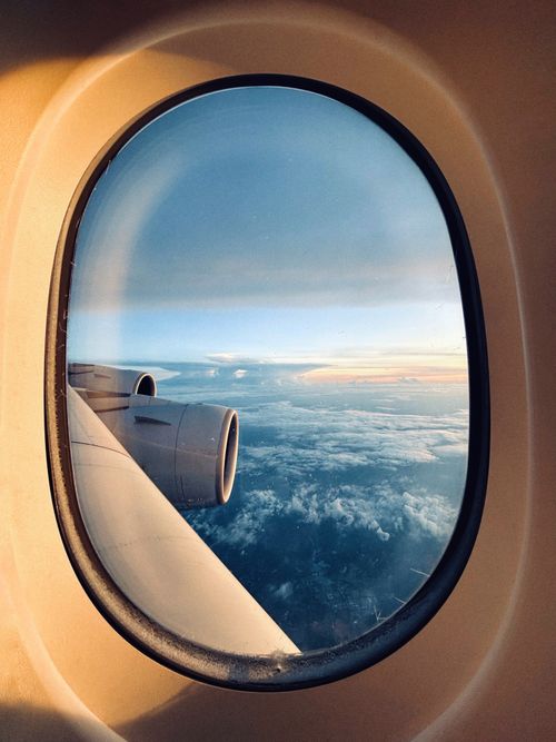 Free A stunning sunrise view from an airplane window, capturing clouds and wing. Stock Photo