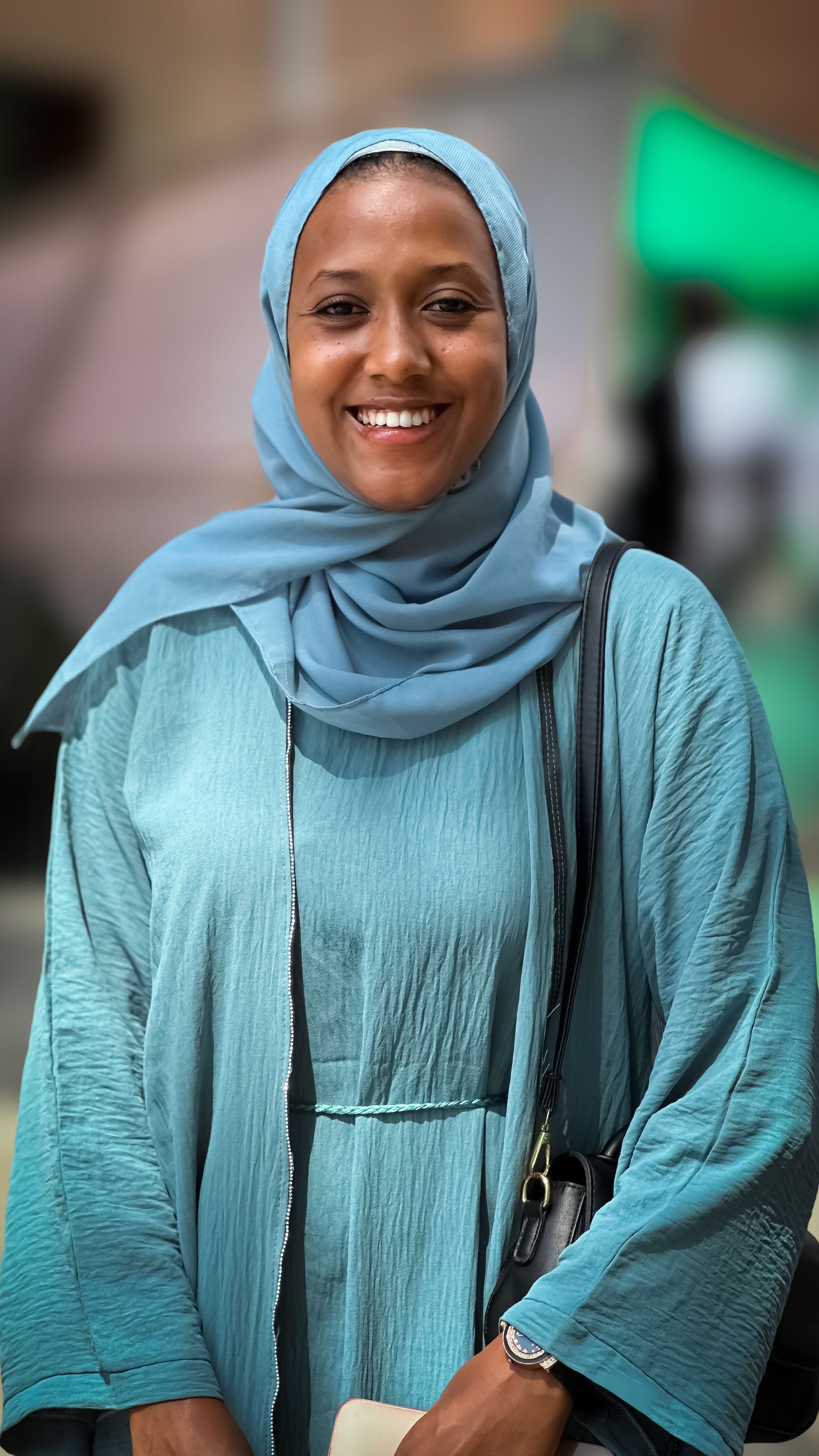 Smiling Woman in Blue Hijab and Dress Outdoors · Free Stock Photo