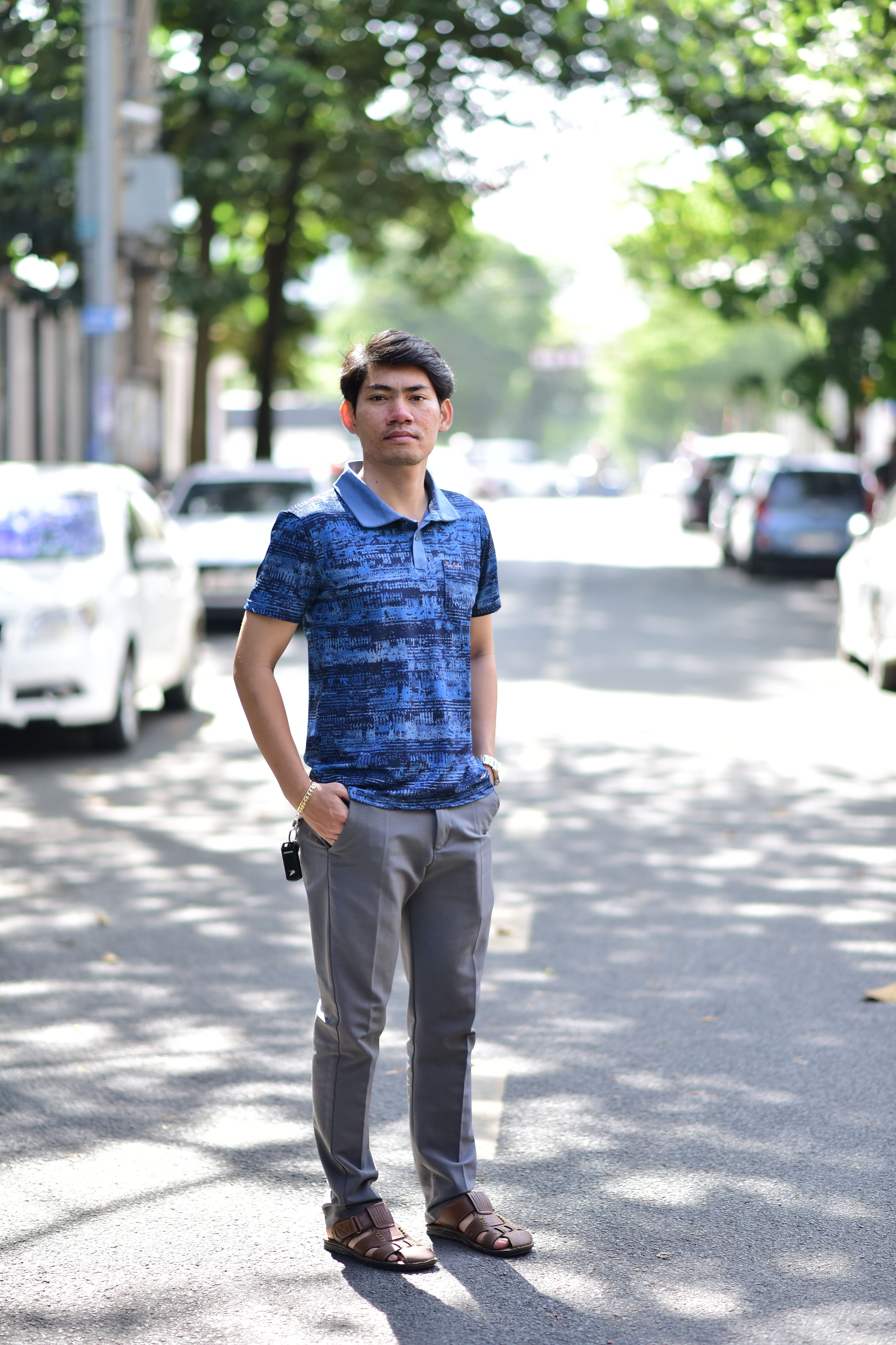 Man Posing Relaxed on Sunny Urban Street · Free Stock Photo